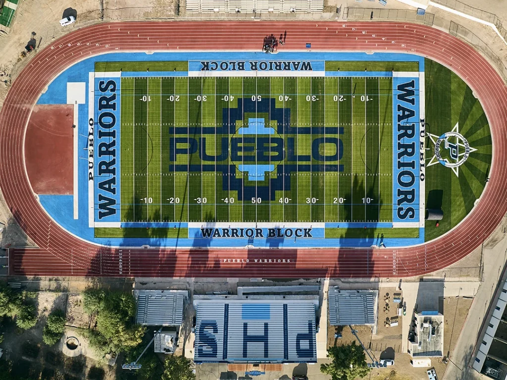 Overhead aerial view of the Pueblo High School Warriors football field, track and PHS bleachers